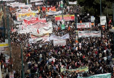 ATHENS, GREECE - FEBRUARY 24 : Crowds of people march through the streets during a 24-hour general strike on February 24, 2010 in Athens, Greece. Greece ground to a halt and flights were grounded as unions staged a one-day general strike in protest against the Government's austerity measures designed to contain the massive public deficit.  (Photo by Milos Bicanski/Getty images)